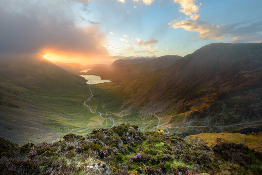 Sun Breaking Through Clouds Onto Mountain Landscape In The Lake District With View Of Buttermere And Fleetwith Pike. Cumbria, UK.