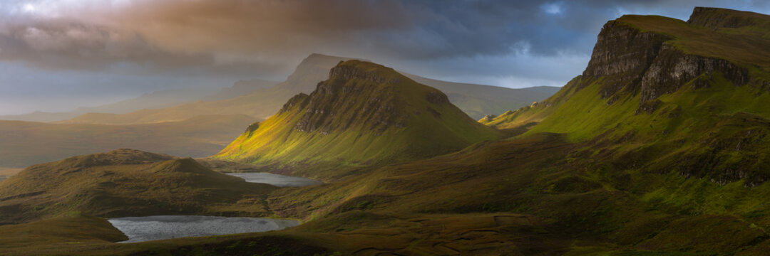 Dramatic mountains of the Isle of Skye seen from viewpoint on the Quiraing. Large panorama with dark moody clouds. Scotland landscapes, Inner Hebrides, UK.