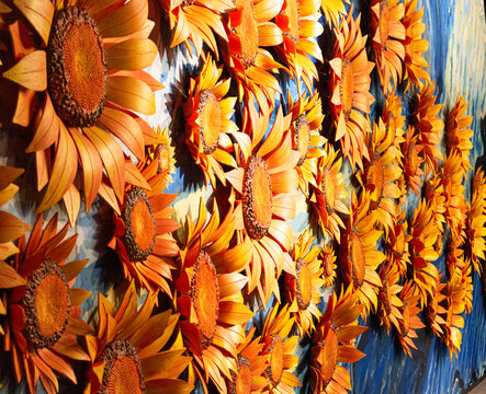 Wall of handmade orange and yellow handmade sunflowers