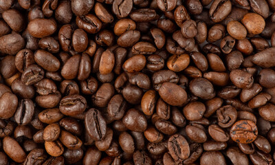 Fresh roasted coffee beans texture. Texture of roasted coffee beans. Freshly roasted coffee beans background. roasted coffee bean background, top view