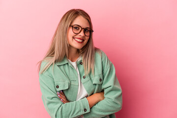 Young russian woman isolated on pink background laughing and having fun.