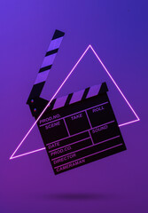 Film clapper board in neon light with triangle. Cinema industry, entertainment. Minimalism, concept...
