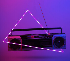Retro radio tape recorder. in blue-red neon gradient light with triangle. Pop culture. 3D photo....