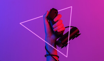 Hands holding retro joystick in blue-red neon gradient light with triangle. Old gaming. 80s retro wave. Minimalism © splitov27