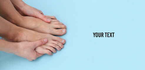 Female bare feet on blue background. Beauty Care Concept. Copy space