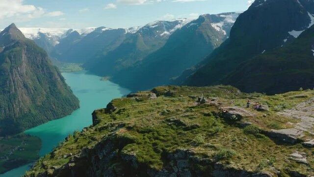 Tourists On Klovane Mountain Peak Overlooking Oldevatnet Lake In Vestland County, Norway. - aerial