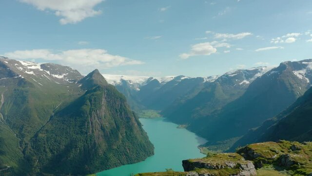 Scenic Mountain Views Near Olden With Calm Blue Waters Of Lake In Norway. - aerial