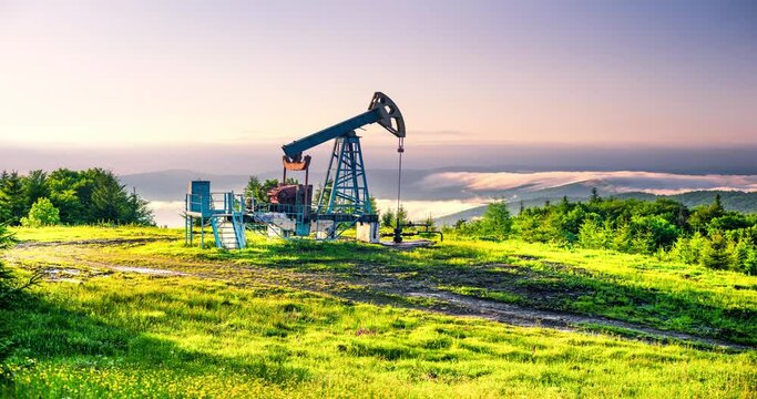 Rapid movement of clouds over a classic oil gas pump in the carpathians Ukraine in time-lapse technique vide. An ancient hydrocarbon deposit in Europe, more than a hundred years old.