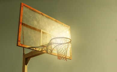 Basketball hoop against the sky. Bright sunshine