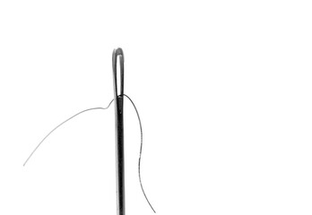 Needle with a thread though the eye. Close up image isolated on white background.