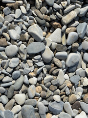 Pebbles or stones on the beach. 