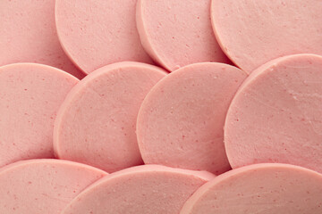 Slices of tasty boiled sausage as background, top view © New Africa