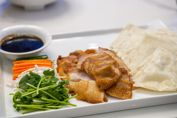 A delicious Chinese dish, grilled meat with noodle sauce and cilantro carrots
