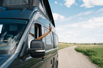 Woman with smartphone in broken car