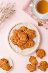 Mooncake biscuits are little sweet snacks which are like the outer layer of the mooncake. Unlike the traditional baked mooncakes, these biscuits are usually made without filling and are much thicker.