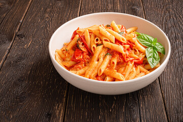 Close up plate CHERRY TOMATO PASTA Like an Italian on wooden background