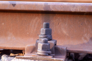 Old rusty bolts for mounting rails on railroad track.