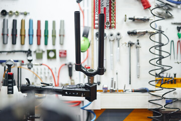 Rack with bicycle fork near tools