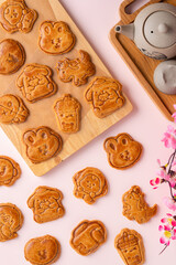 Mooncake biscuits are little sweet snacks which are like the outer layer of the mooncake. Unlike the traditional baked mooncakes, these biscuits are usually made without filling and are much thicker.