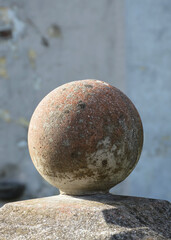 Fototapeta na wymiar Stone ball finial on pedestal. Traditional post topper or post cap