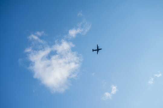 Flying passenger plane on blue sky background