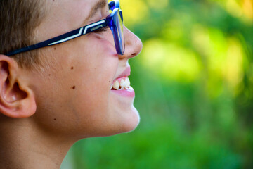 Close up of happy smile of little boy  with eyeglasses.  Dental medical care.  Dental  bruxism...