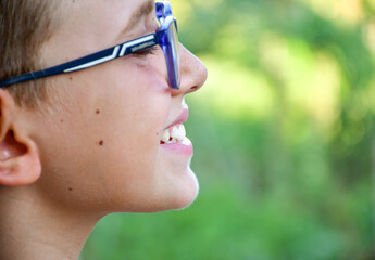 Close up of happy smile of little boy  with eyeglasses.  Dental medical care.  Dental  bruxism...