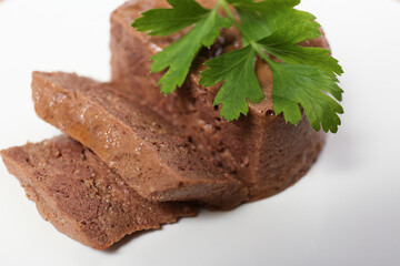 Pate with parsley on white plate, closeup. Pet food
