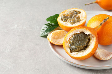 Delicious ripe granadillas on light table, closeup. Space for text