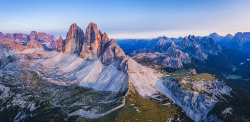 Aerial panoramic view of Tre Cime di Lavaredo pinked colored during sunset. Dolomites, Italy