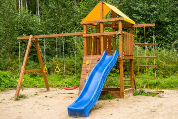 Small wood log playhouse wooden slide on children playground