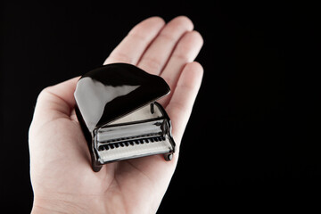image of piano hand dark background 