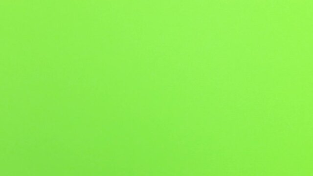 Stop Motion Animation_Green paper ball unwrapping on a dark purple background_Green screen
