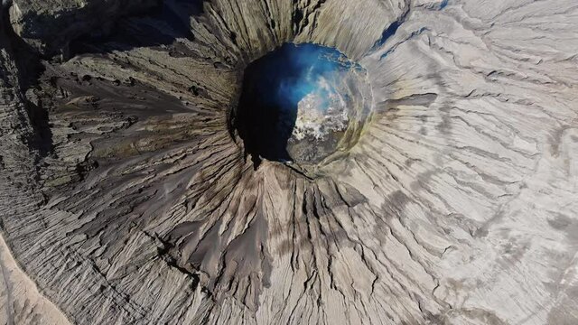 Above view texture of active volcano bromo with smoke on middle hole