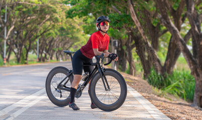 Portrait sport woman wearing sport suite helmet,glove and glasses,she competition on  bicycle bike is adventure and extream game concept.