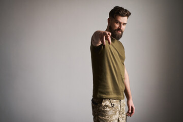 Bearded military man wearing uniform and showing 