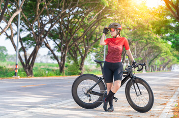 Portrait sport woman wearing sport suite helmet,glove and glasses,she competition on  bicycle bike is adventure and extream game concept.