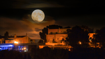 Fotografia nocturna con la luna llena en una urbanización de la Costa Brava © gurb101088