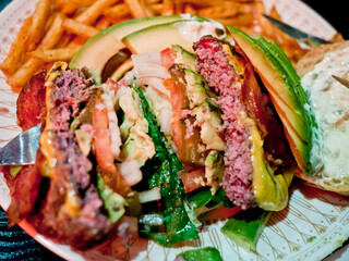 Handmade burger cut in half.