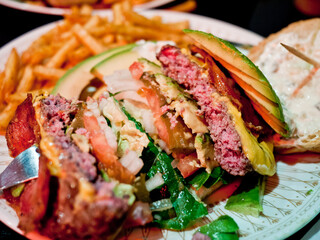 Handmade burger cut in half.