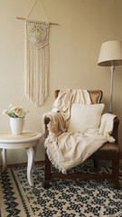 Home decor photo, Boho style room with Macrame wall hanger, lamp, chair and desk.