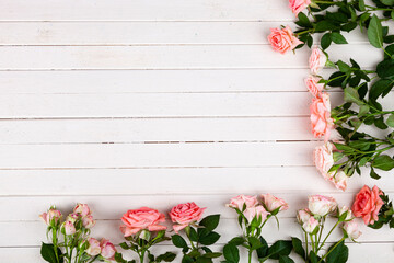 Fototapeta na wymiar Border of pink roses on a wooden background,