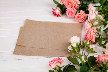 Pink roses and paper for text