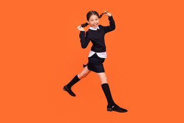 Fototapeta na wymiar Full size profile side photo of young girl happy positive smile have fun playful jump isolated over orange color background