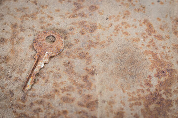 Old rusty key on grunge background. Vintage door key. Antique key on weathered background. Security...