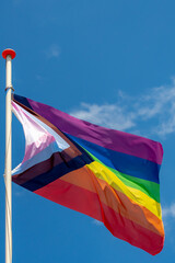 Worldwide LGBTQ community concept with progress pride flag (new design of rainbow flag) waving in...