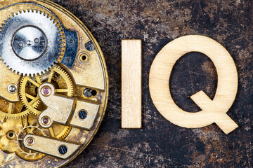 Intelligence quotient, iq test score and level concept. Antique clockwork gears with letters.
