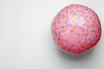 Pink beach ball on white background, top view. Space for text