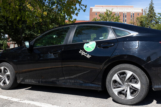 Zipcar logo on an automobile ready to rent for minutes, an hour or a day. Zipcar is a subsidiary of Avis Budget Group.