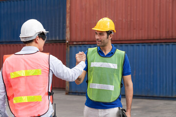 Engineer and foreman join hands to work success loading containers box from Cargo freight ship at Cargo container shipping